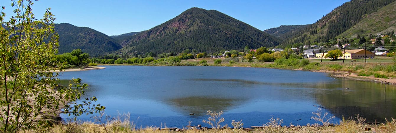 Palmer Lake reflecting Ben Lomond Mountain on a clear summer day in Palmer Lake, Colorado